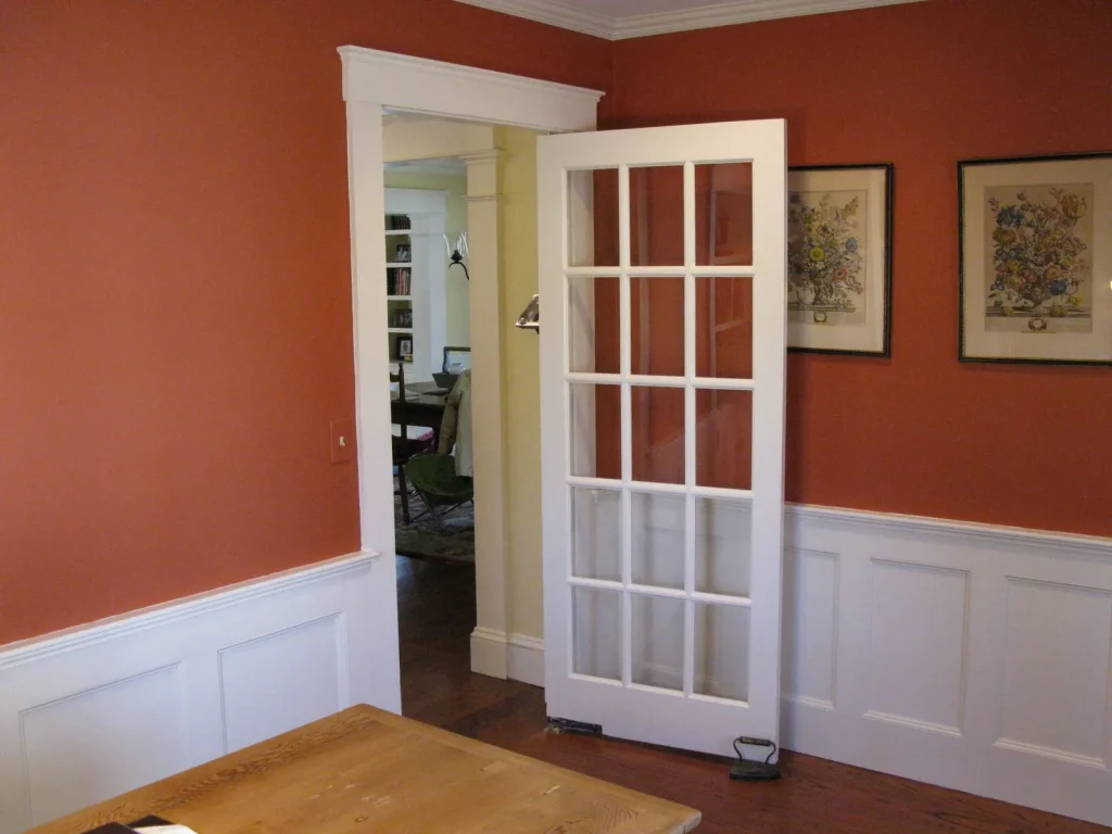 Interior view with orange walls and white door
