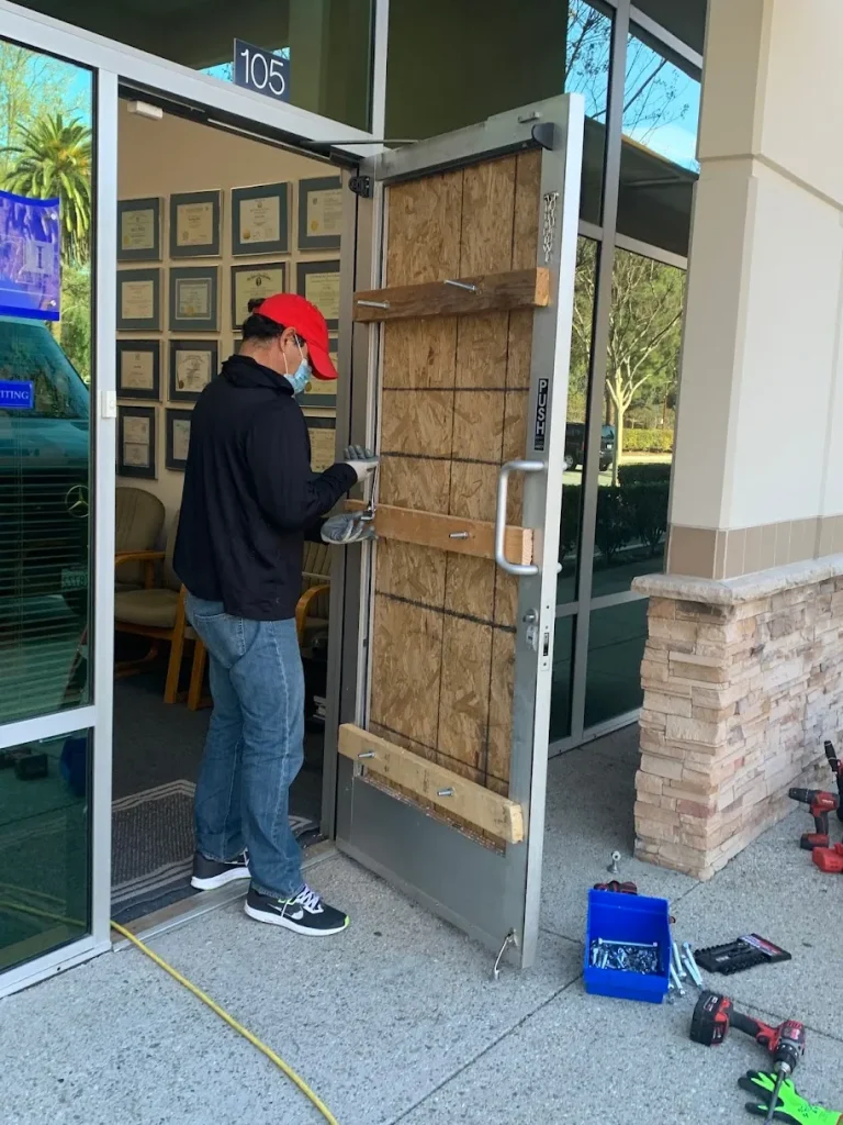 Man boarding up door