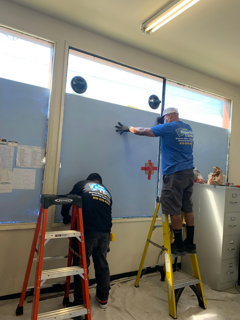 Technicians replacing large commercial window glass on-site in Canoga Park, CA
