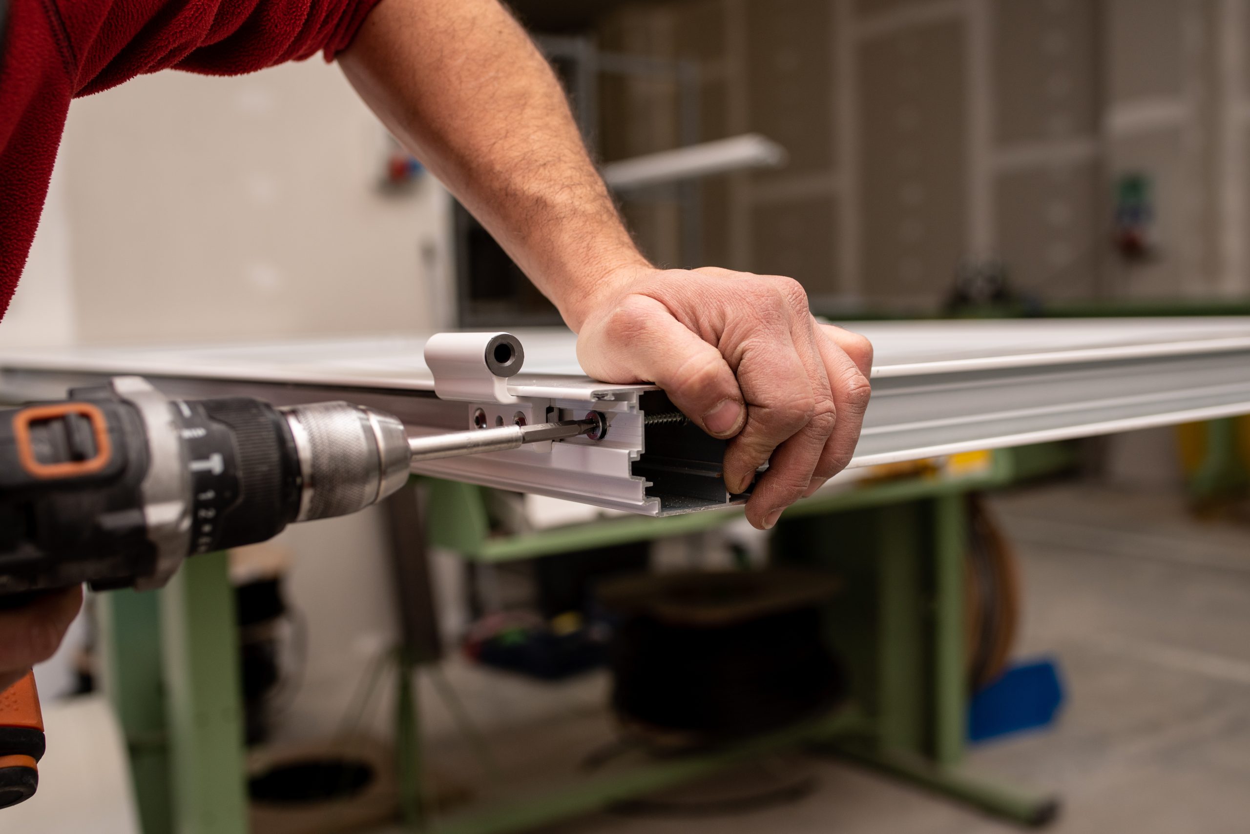 Expert repairing worn rollers to restore proper sliding door function.