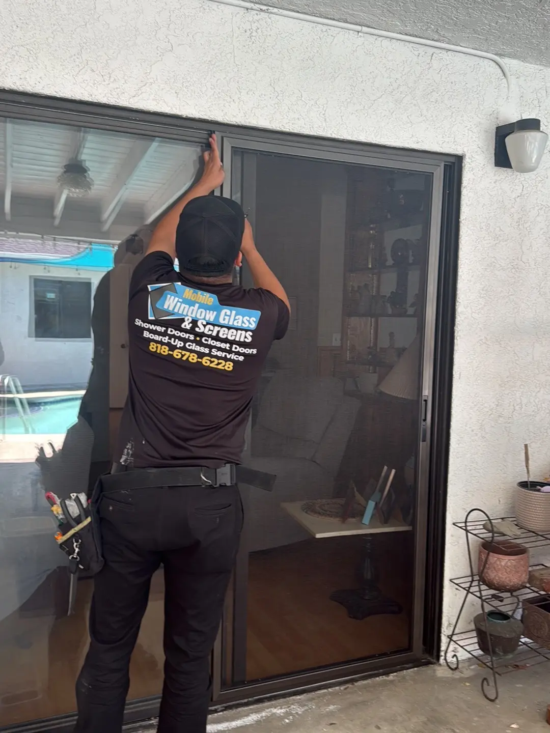 Shattered patio door glass panel after an impact accident at a local home.